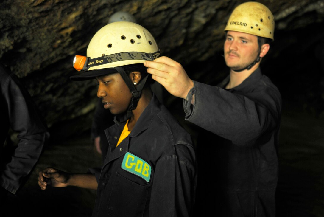 Airman 1st Class Andrew Johnson, 11th Force Support Squadron force management technician, reaches out to adjust Airman 1st Class Keomi Kelly's, 744th Communications Squadron knowledge operations, left, headlamp before a JBA Chapel Wilderness Retreat spelunking expedition Sept. 22. Caving, or spelunking, was one of many activities Airmen who attended the retreat experienced during the five-day PTDY. (U.S. Air Force photo/Airman 1st Class Lindsey A. Beadle)