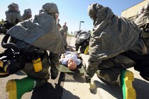 MINOT AIR FORCE BASE, N.D. -- Members of 5th Medical Group’s decontamination team prepare to move a simulated patient over to a decontamination area during an exercise here Sept. 22. During the mass casualty exercise, personnel from the various factions of the 5th MDG responded setting up patient treatment areas throughout the entire medical building, each holding different responsibilities. The 5th MDG conducts exercises like these to test the readiness and effectiveness of medical contingency response plan procedures. (U.S. Air Force Photo/Airman 1st Class Jose L. Hernandez)

