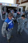 MINOT AIR FORCE BASE, N.D. -- Members of the 5th Medical Group’s medical triage team, unload victims off an ambulance during a mass casualty exercise here Sept. 22. During the mass casualty exercise, personnel from the various factions of the 5th MDG responded setting up patient treatment areas throughout the entire medical building, each holding different responsibilities. The 5th MDG conducts exercises like these to test the readiness and effectiveness of medical contingency response plan procedures. (U.S. Air Force Photo/Airman 1st Class Jose L. Hernandez)