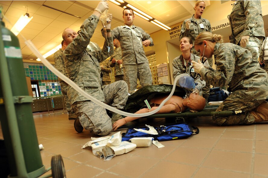 MINOT AIR FORCE BASE, N.D. -- Members of the 5th Medical Group’s medical triage team, conduct medical recovery procedures on  simulated patient at the Hospital Atrium during a mass casualty exercise Sept. 22. The 5th MDG conducts exercises like these to test the readiness and effectiveness of medical contingency response plan procedures. (U.S. Air Force Photo/Airman 1st Class Jose L. Hernandez)