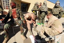 MINOT AIR FORCE BASE, N.D. -- 5th Medical Group personnel took part in an exercise here Sept. 22, which involved a simulated terrorist attack with the use of a chemical agent at a designated location. Personnel from the various factions of the 5th MDG responded setting up patient treatment areas throughout the entire medical building, each holding different responsibilities, among them a decontamination zone to treat infected patients. The 5th MDG conducts exercises like these to test the readiness and effectiveness of medical contingency response plan procedures. (U.S. Air Force Photo/Airman 1st Class Jose L. Hernandez)