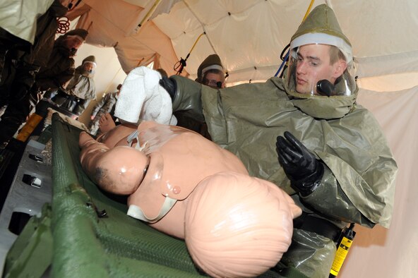 MINOT AIR FORCE BASE, N.D. -- Airman 1st Class James Brigance, 5th Medical Operations Squadron medical technician, conducts decontamination procedures on a simulated patient during a mass casualty exercise here Sept.22. The 5th Medical Group conducts exercises like these to test the readiness and effectiveness of medical contingency response plan procedures. (U.S. Air Force Photo/Airman 1st Class Jose L. Hernandez)