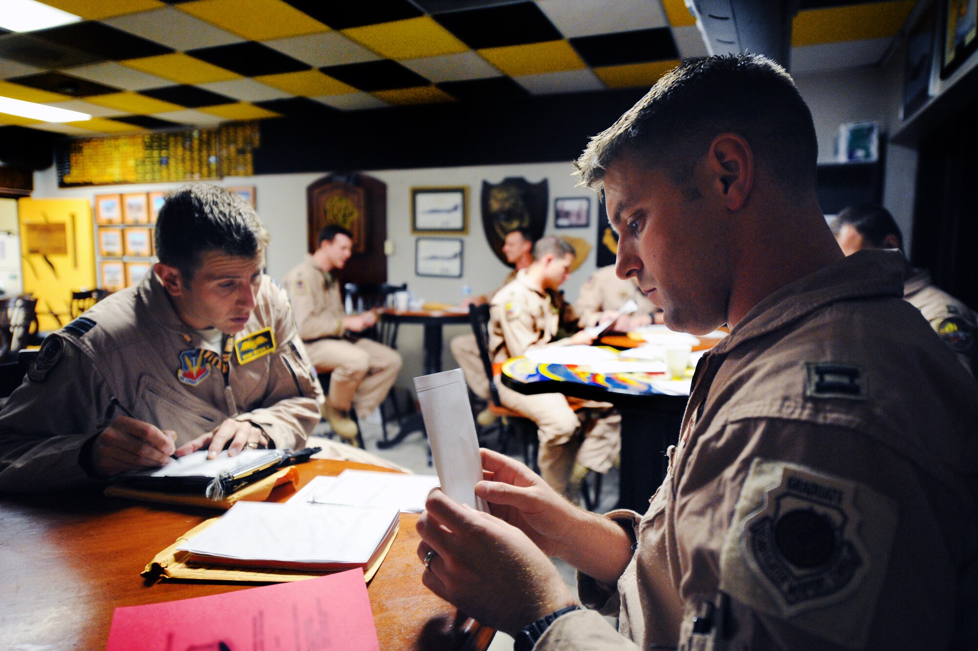 British Royal Air Force Flight Lt. Hugh Nichols, chief of air crew equipment, and U.S. Air Force Capt. Patrick Mcgarry, 79th Fighter Squadron assistant director of operations and F-16 Fighting Falcon pilot go over pre-departure planning, Shaw Air Force Base, S.C., Sept. 24, 2011. Eighteen 79th Fighter Squadron F-16 Fighting Falcon aircraft deployed in support of Operation Unified Protector.(U.S. Air Force photo by Airman 1st Class Tabatha Duarte/Released)