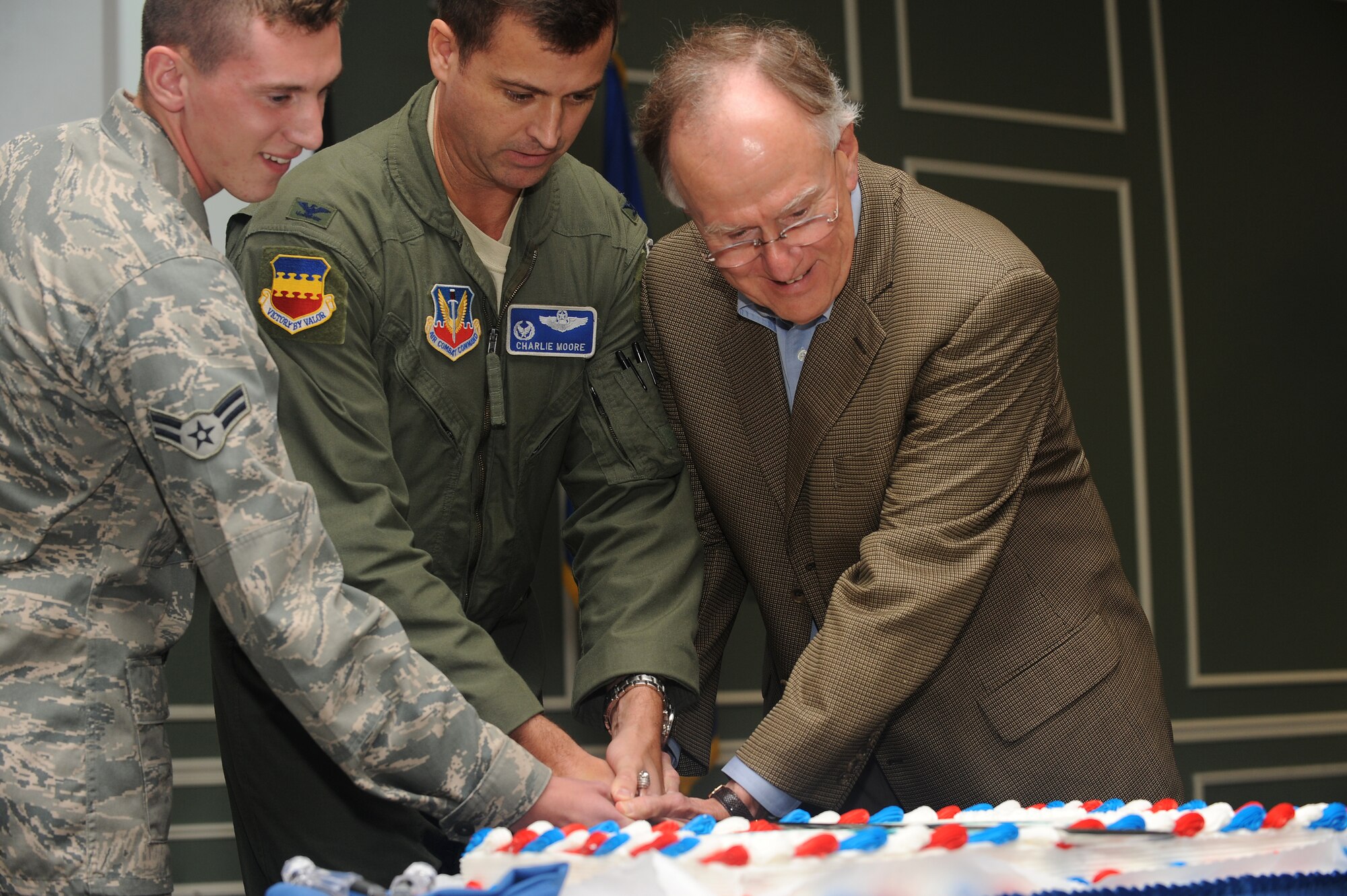 U.S. Air Force Col. Charlie Moore, 20th Fighter Wing commander, (center) and Sumter Mayor Joseph McElveen, Jr., along with Airman 1st Class Christopher Dybalski, 20th Logistics Readiness Squadron, cut the first slice of cake during a cake cutting ceremony Sept. 23, 2011, Shaw Air Force Base, S.C. More than 200 Team Shaw and Sumter area members gathered at the Carolina Skies Club in commemoration of the 70th Anniversary of Shaw Field and the 64th birthday of the Air Force. (U.S. Air Force photo by Airman 1st Class Ashley Gardner/Released)



