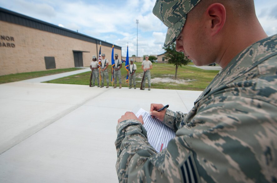 U.S. Air Force Senior Airman Justin Baker, USAF Honor Guard core supervisor, from Bolling Air Force Base, Washington D.C., marks down information on his check list during an evaluation of Moody Honor Guard members at Moody AFB, Ga., Sept. 21, 2011. Baker has been an instructor for the USAF Honor Guard for a year. (U.S. Air Force photo by Airman 1st Class Joshua Green/Released)
