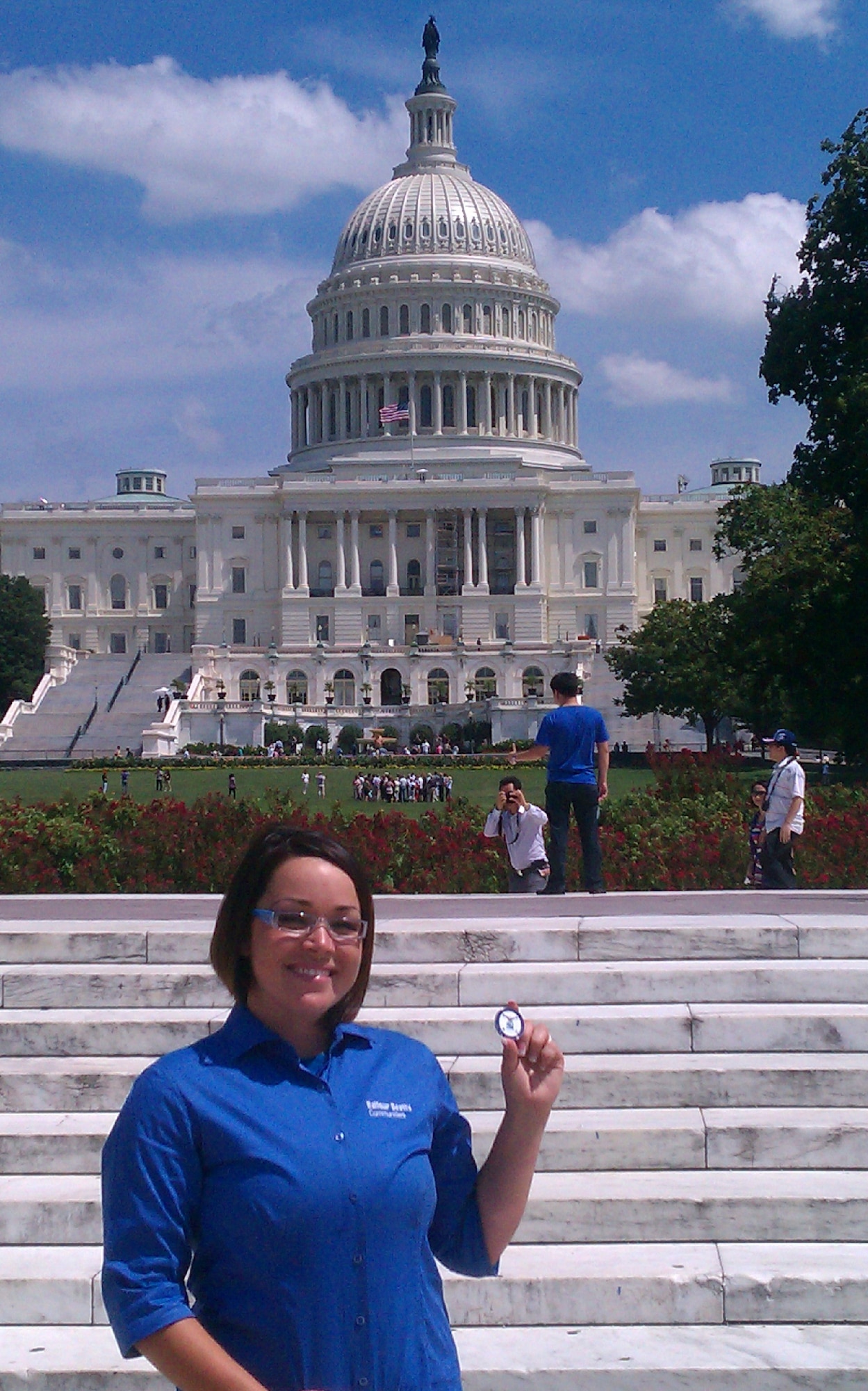 Amy Adams, Balfour Beatty LifeWorks coordinator, shows off the coin she was presented Aug. 24, 2011 by Secretary Yonkers after briefing the Assistant Secretary of the Air Force, and about 60 other people around the world via telecom, on the LifeWorks programs and taking care of the military family at the Pentagon. (courtesy photo)