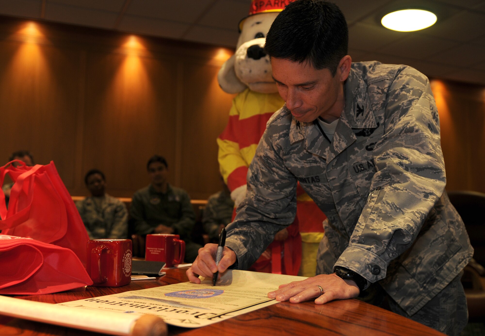 ROYAL AIR FORCE LAKENHEATH, England - Col. John T. Quintas, 48th Fighter Wing commander, signs the National Fire Prevention Week proclamation on Sept. 27, 2011. This year's Fire Prevention Week focuses on protecting your family from fire, as well as keeping homes safe from the leading causes of home fires. (U.S. Air Force photo by Airman Cory D. Payne)