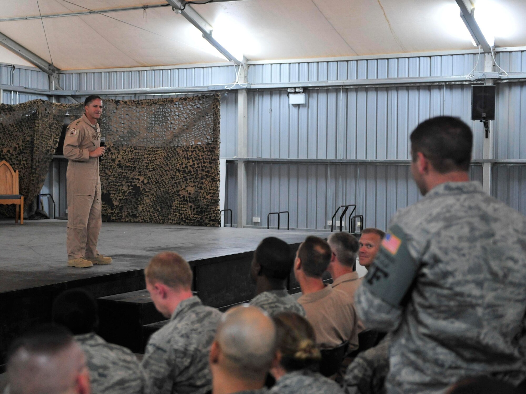 Lt. Gen. David Goldfein, commander, U.S. Air Forces Central Command, takes a question from Staff Sgt. Matthew Phillips, of the 380th Expeditionary Security Forces Squadron, during an all-call briefing at the 380th Air Expeditionary Wing, Sept. 27, 2011. This was the general's first visit to the 380th AEW since becoming the AFCENT commander. Phillips is a native of Houston, Texas and is deployed from Hurlburt Field, Fla. (U.S. Air Force photo/Tech. Sgt. Patrick Mitchell)