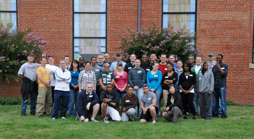 Before loading their charter bus, Joint Base Andrews Chapel Wilderness Retreat attendees pose for a group photo Sept. 19 outside Chapel 1 here. The five-day retreat consisted of various physically-demanding and team-building outdoor workshops, all designed to inspire confidence and ignite leadership potential in each Airmen who attended the retreat. (U.S. Air Force photo/Airman 1st Class Lindsey A. Beadle)