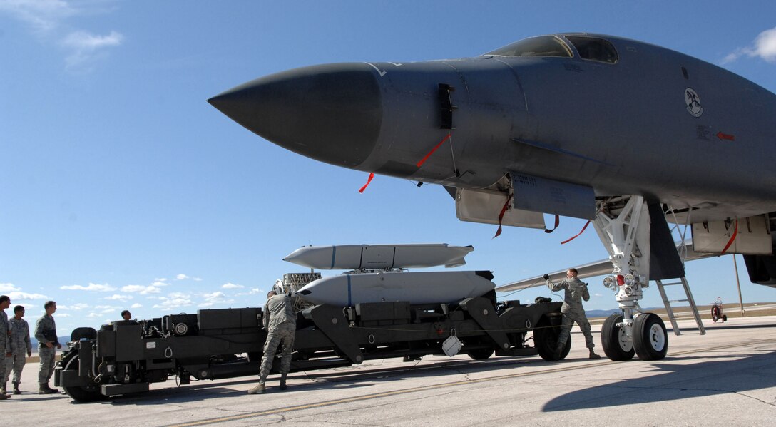 Weapons load crew members from the 28th Aircraft Maintenance Squadron, use a munitions handling unit trailer to load a Joint Air-to-Surface Stand-off Missile on a B-1B Lancer during the Global Strike Challenge on Ellsworth Air Force Base, Sept. 21, 2011. The goals of the competition include recognizing superior performers, enhancing esprit de corps while strengthening teamwork and improving readiness and combat capabilities through preparation, innovation, competition and teamwork. (U.S. Air Force photo by Tech. Sgt. Jerry Fleshman/Released)