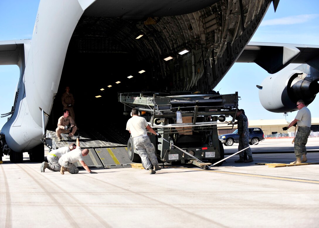 Airmen with the 28th Logistics Readiness and Civil Engineer Squadrons carefully load a universal maintenance stand into a C-17 Globemaster III from McChord Air Force Base, Wash, on Ellsworth Air Force Base, S.D., Sept. 23, 2011. The cargo was used in support of ongoing operations in Southwest Asia. (U.S. Air Force photo by Tech. Sgt. Jerry Fleshman/Released)