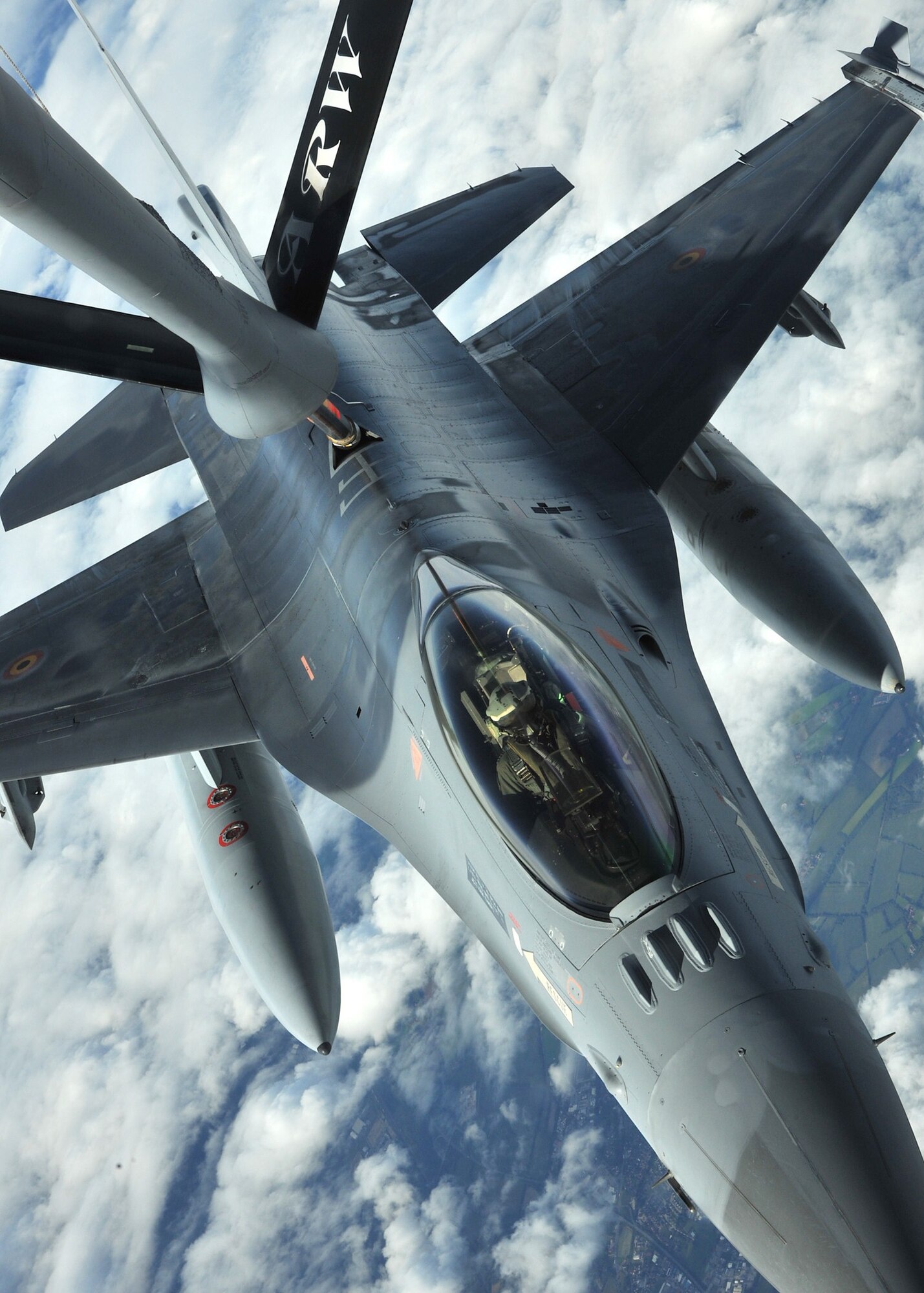 RAF MILDENHALL, England - A Belgian F-16 Fighting Falcon receives fuel from a KC-135 Stratotanker assigned to the 100th Air Refueling Wing over Germany Sept. 21, 2011. The F-16 participated in Exercise Brilliant Arrow; a multinational air exercise conducted by NATO and was one of 28 fighter aircraft participating. (U.S. Air Force photo by Senior Airman Jerilyn Quintanilla)     
