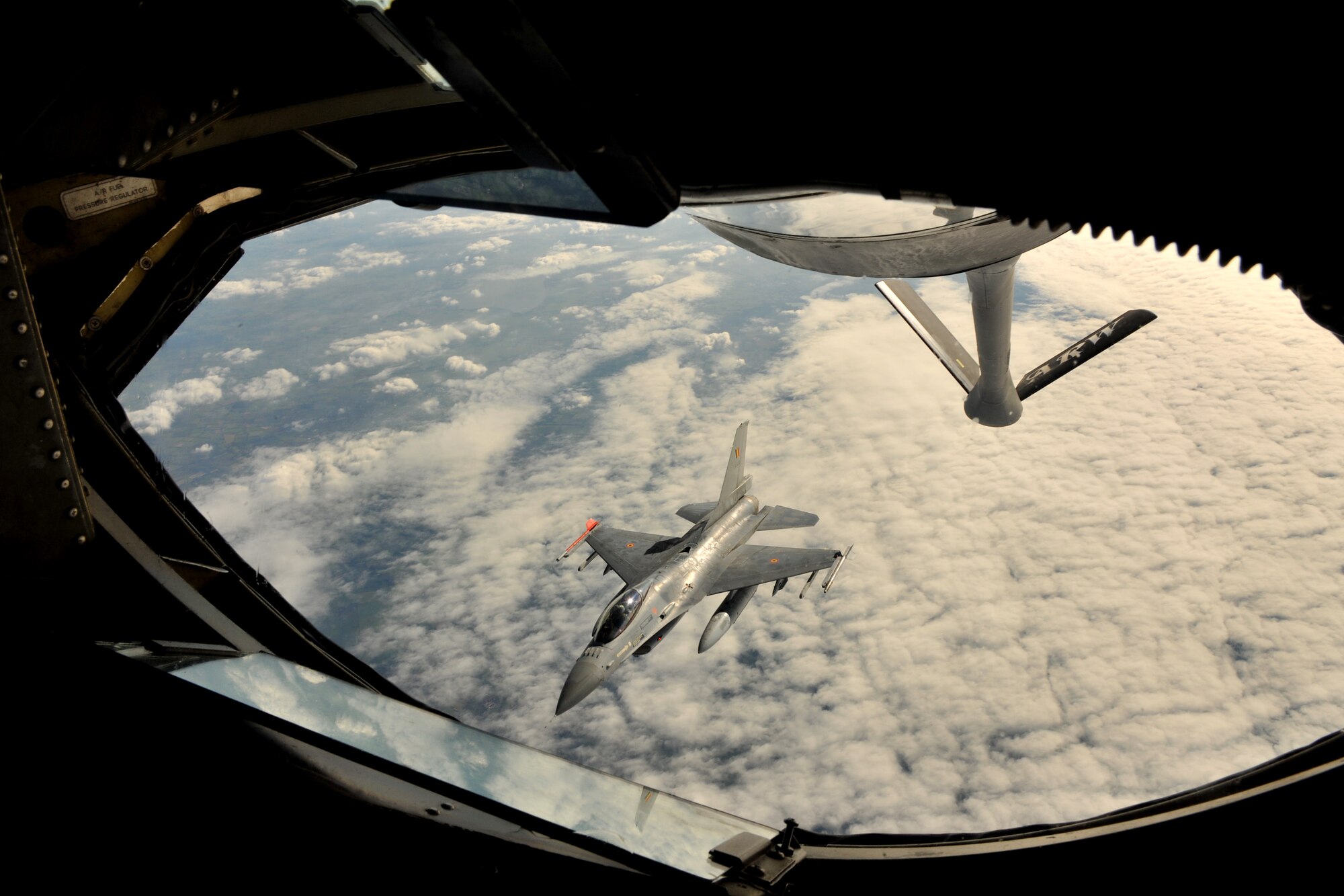 RAF MILDENHALL, England - A Belgian F-16 Fighting Falcon breaks away from the boom of a KC-135 Stratotanker, assigned to the 100th Air Refueling Wing, after receiving fuel over Germany Sept. 21, 2011. The F-16 participated in Exercise Brilliant Arrow, a multinational air exercise. Germany, Belgium, the United States and Turkey were among the participating nations. (U.S. Air Force photo by Senior Airman Jerilyn Quintanilla)