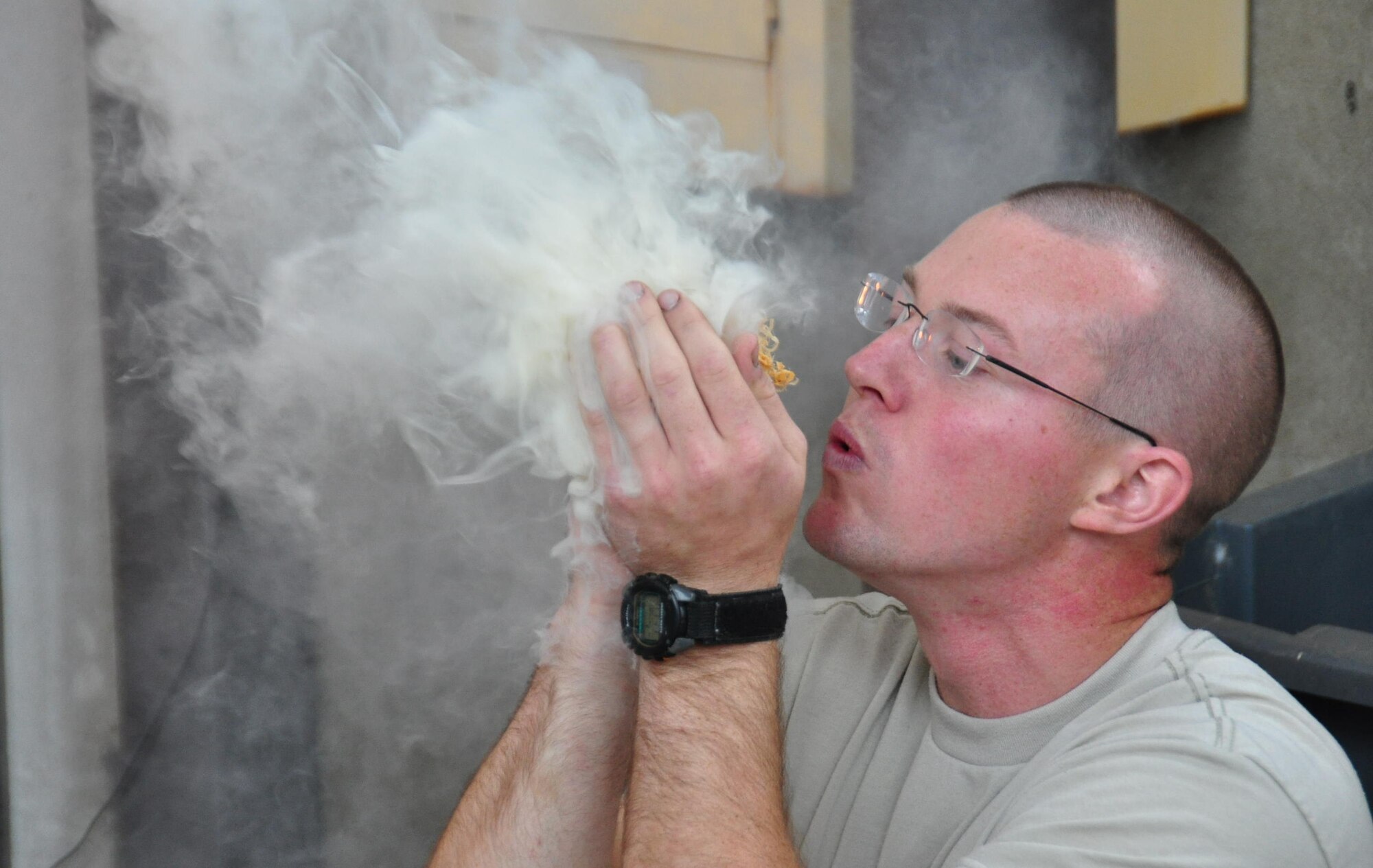 Staff Sgt. Adam Craft, 934th Airlift Wing Survival Evasion Rescue and Escape instructor, demonstrates starting a fire using only wood found in the wild for employees of Wings Financial Advisors during their tour Sept. 27. (Air Force Photo/Paul Zadach)