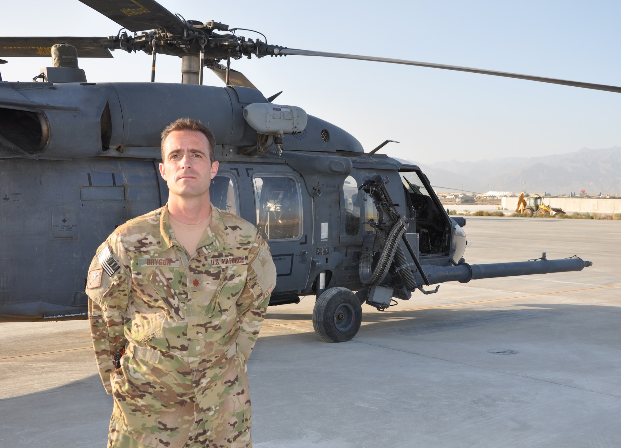BAGRAM AIRFIELD, Afghanistan -- Maj. Parkin Bryson, 83rd Expeditionary Rescue Squadron HH-60 Pave Hawk pilot, poses for a photo with his aircraft here Sept. 26, 2011. Bryson helped completed a high-risk rescue of two wounded Afghan National Army personnel during a dynamic mission Sept. 11, 2011. Two HH-60G Pave Hawks had to fly over 12,000-foot mountains and perform an aerial refueling. Bryson is from Durango, Colo. (U.S. Air Force photo/Staff Sgt. John Wright)