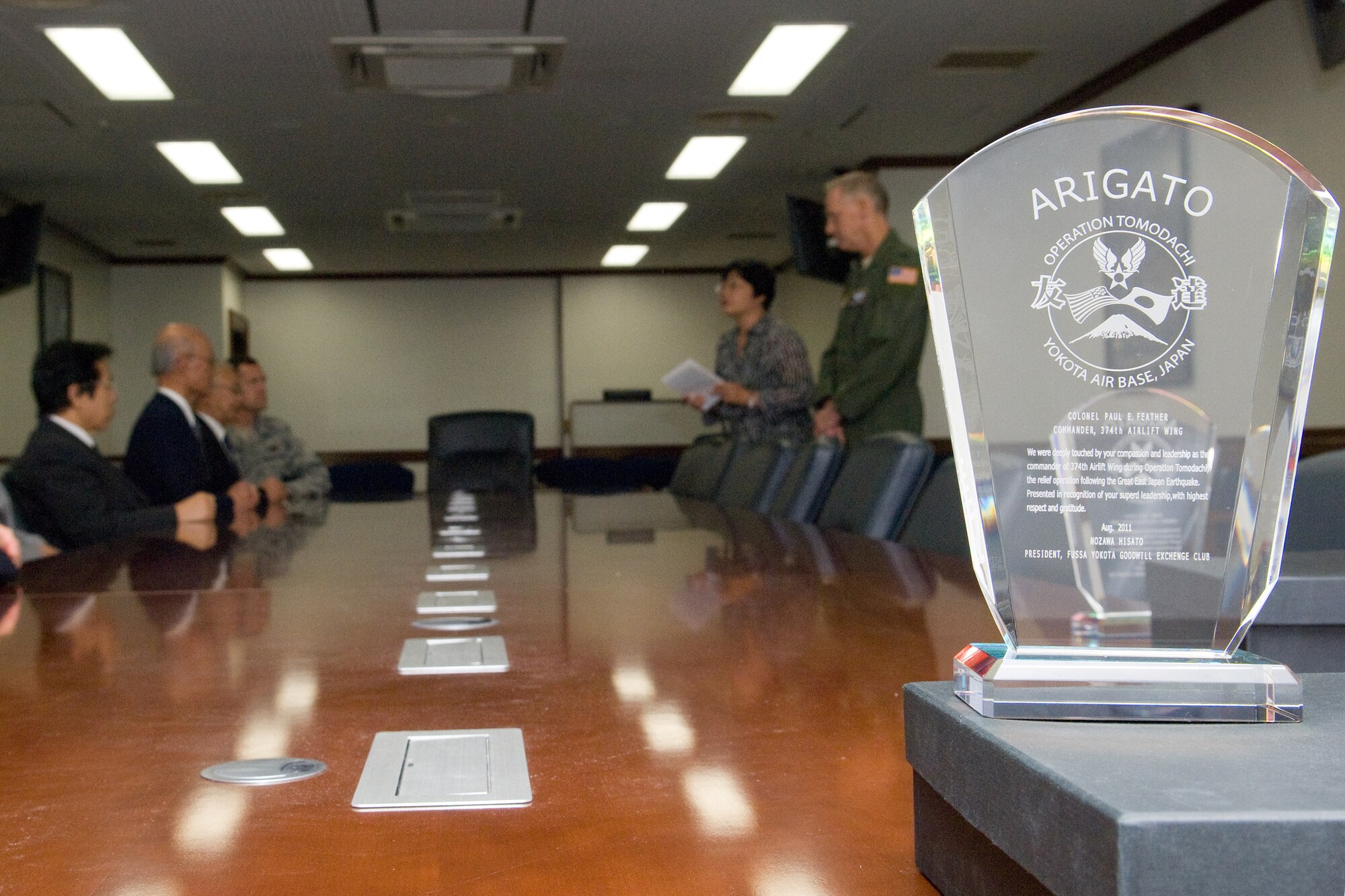 YOKOTA AIR BASE, Japan -- The Fussa Yokota Goodwill Exchange club presents an arigato plaque to Col. Otto Feather, 374th Airlift Wing commander, and Col. Todd Freece, 374th Mission Support Group commander, at Yokota Air Base, Japan, 28 Sept. 2011. (U.S. Air Force photo/Osakabe Yasuo)