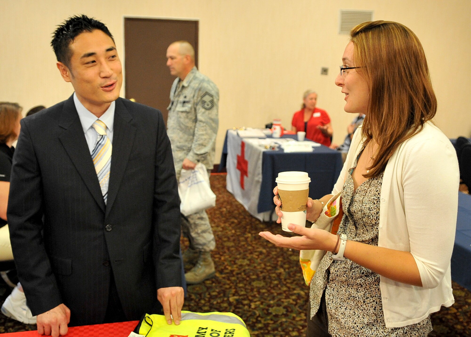 Mr. Joseph Lee, 51st Force Support Squadron, Airman and Family Readiness Center community readiness specialist, talks with Mrs. Sasha King during the job fair held Sept. 09, 2011. The job fair was held to support the employment endeavors of military spouses and family members. (U.S. Air Force photo/Senior Airman Adam Grant)     