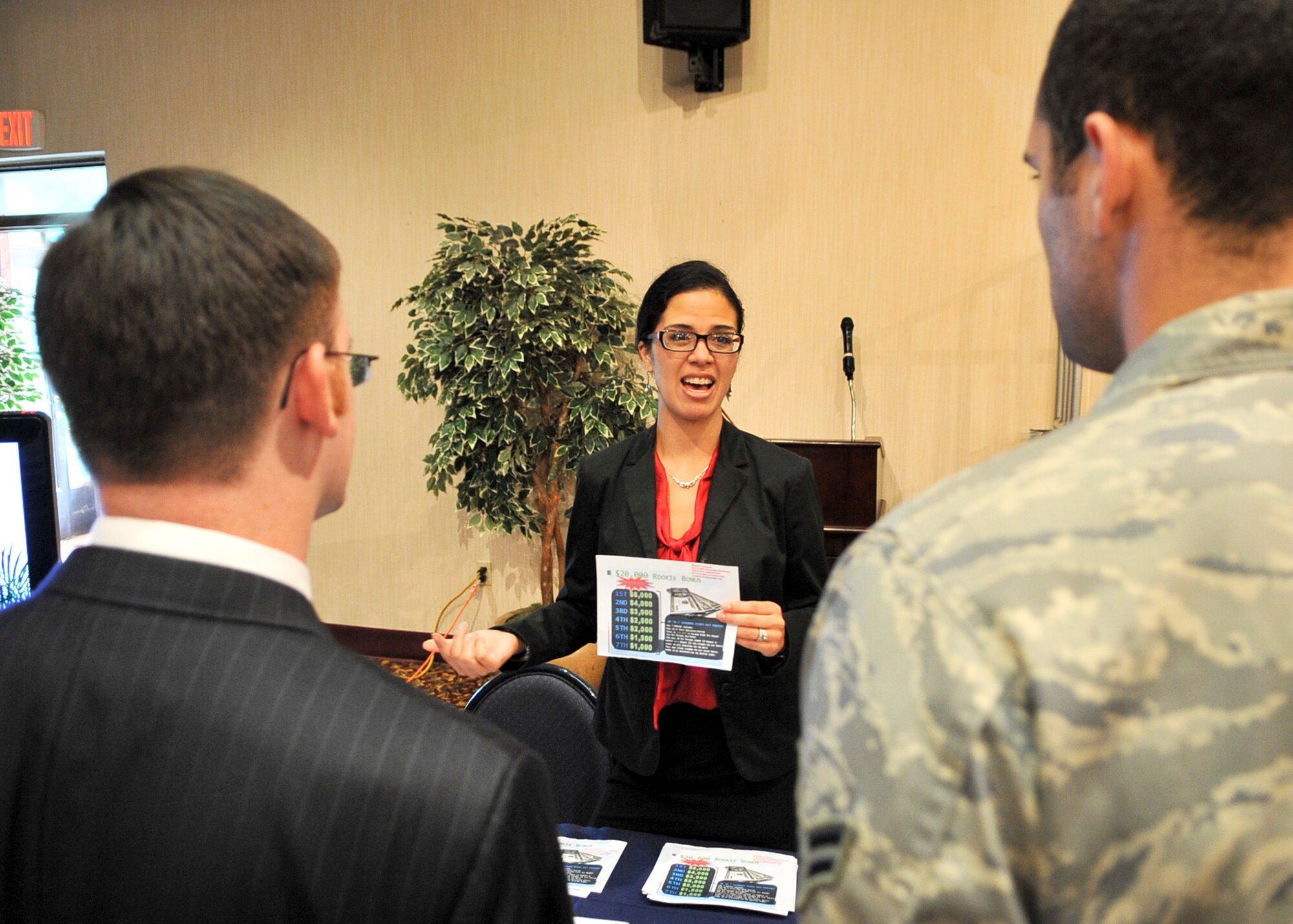 Mrs. Michelle Yakamota, Advocare distributor, speaks with both civilian and military members during the peninsula-wide job fair held Sept. 09, 2011. The job fair was held to support the employment endeavors of military spouses and family members. (U.S. Air Force photo/Senior Airman Adam Grant)    