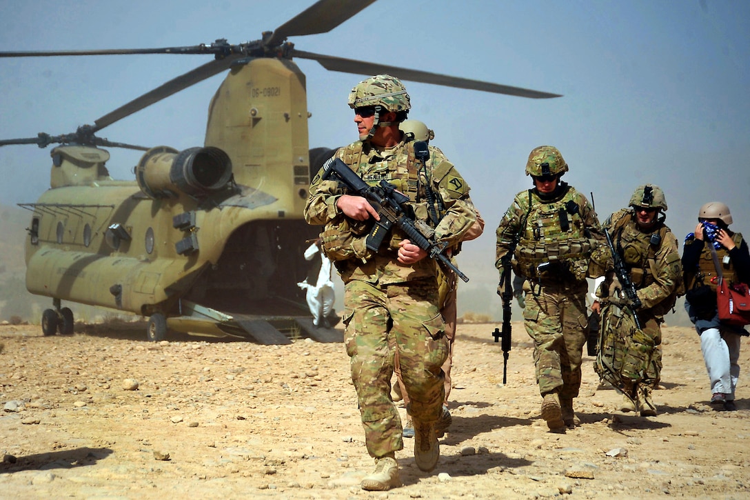 U.S. Army 2nd Lt. Joel Beaulieu escorts members of the provincial government and the provincial reconstruction team off a CH-47 Chinook helicopter to attend a shura with local elders in the Purchaman district of Afghanistan's Farah province, Sept. 26, 2011. Beaulieu is assigned to Company C, 1st Battalion, 182nd Infantry Regiment. 