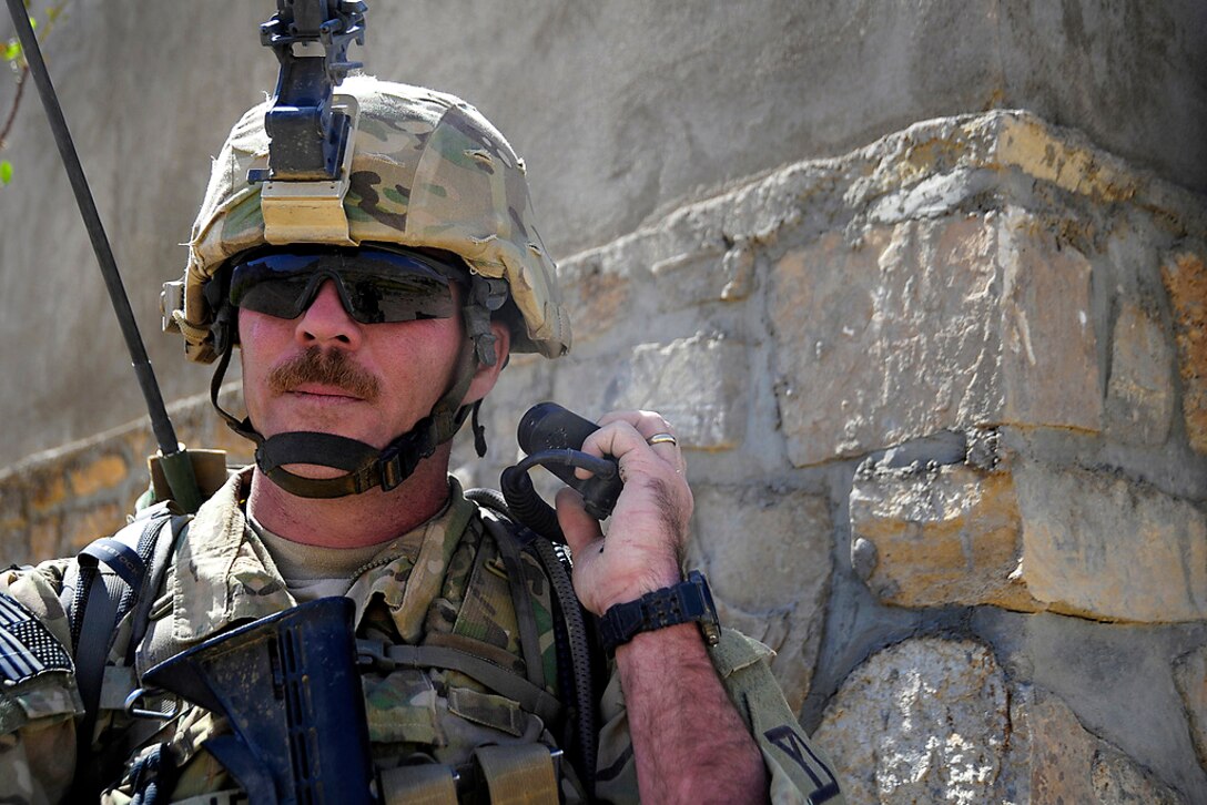 U.S. Army Sgt. Peter Lescord relays information over the radio while on ...