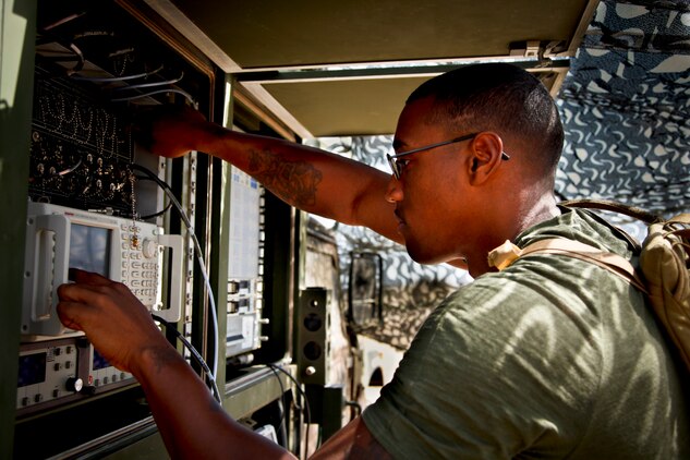 Sergeant Curtis M. Brown, switching chief, communications section, 15th Marine Expeditionary Unit, makes a minor adjustment on the Phoenix Satellite Communications terminal at the unit’s field operation on Reconnaissance, Selection and Occupation of Position 95, Sept. 26-29. The training involved Marines from the MEU’s command element and their soon to be Battalion Landing Team - 3rd Battalion, 5th Marine Regiment, 1st Marine Division, Camp Pendleton, Calif. (U.S. Marine Corps photo by Cpl. John Robbart III)
