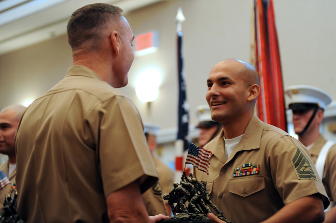 Gunnery Sgt. Gerson G. Ruiz, a recruiter from Fredericksburg, Va., is presented with the U.S. Marine Corps Recruiter of the Year Award by Gen. Joseph F. Dunford, assistant commandant of the Marine Corps, during the Marine Corps enlisted awards parade and presentation ceremony at Marine Corps Base Quantico, Va., Sept. 28, 2011. Ruiz has consistently shown outstanding professional ability in the field of recruitment of young men and women, sending 20 men and women to Marine recruit training during fiscal year 2010.