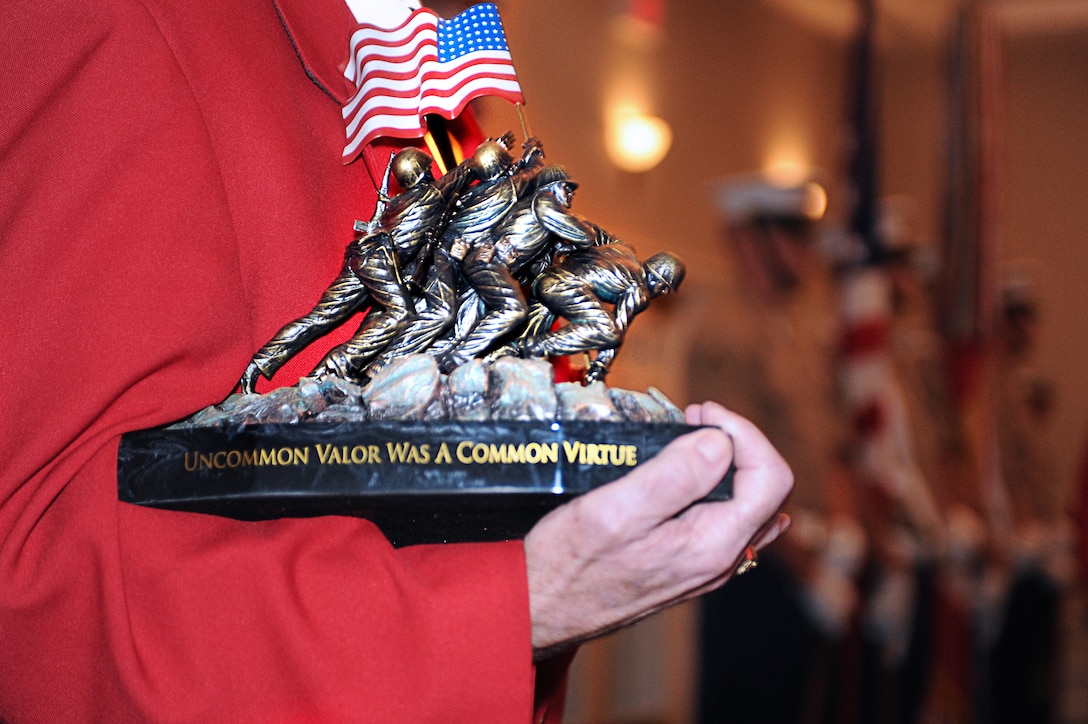 A member of the Marine Corps League's Capital Marine Detachment, holds an award prior to its presentation during the Marine Corps enlisted awards parade and presentation ceremony at Marine Corps Base Quantico, Va., Sept. 28, 2011. Ten Marines and a Navy corpsman were presented awards during the event. The ceremony was part of the 31st Annual Modern Day Military Exposition.