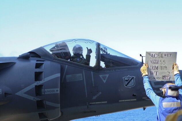 Capt. Aaron Pridgen, pilot of an AV-8B Harrier, with Marine Attack Squadron 214, 31st Marine Expeditionary Unit gives a thumbs up, ensuring he was ready for takeoff, aboard USS Essex, on September 29, 2011. The VMA was conducting this training in preparation for the MEU's Certification Exercise.