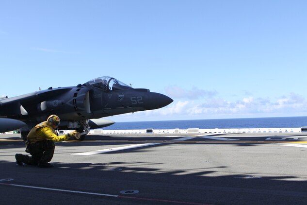 An AV-8B Harrier with Marine Attack Squadron 214, 31st Marine Expeditionary Unit is given the signal for takeoff aboard USS Essex, Sept. 29. The VMA was conducting this training in preparation for the MEU's Certification Exercise. The 31st MEU is the only continuously forward-deployed MEU and remains the nation’s force in readiness in the Asia-Pacific region.