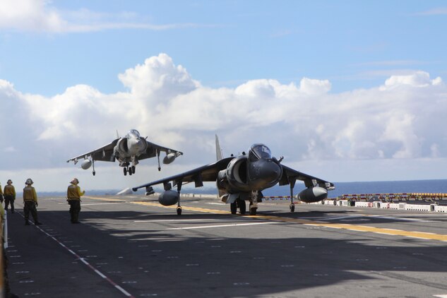 As one AV-8B Harrier prepares for takeoff (foreground), another executes a vertical landing on the flight deck aboard USS Essex, Sept. 29. The Harriers are with the Marine Attack Squadron 214, 31st Marine Expeditionary Unit, and are conducting training in preparation for the MEU's Certification Exercise. The 31st MEU is the only continuously forward-deployed MEU and remains the nation’s force in readiness in the Asia-Pacific region.