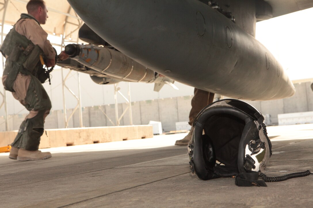 Capt. Daniel Fletcher, a Marine Attack Squadron 513 pilot, inspects an AV-8B Harrier he will pilot on the flightline at Kandahar Airfield, Afghanistan, Sept. 29.