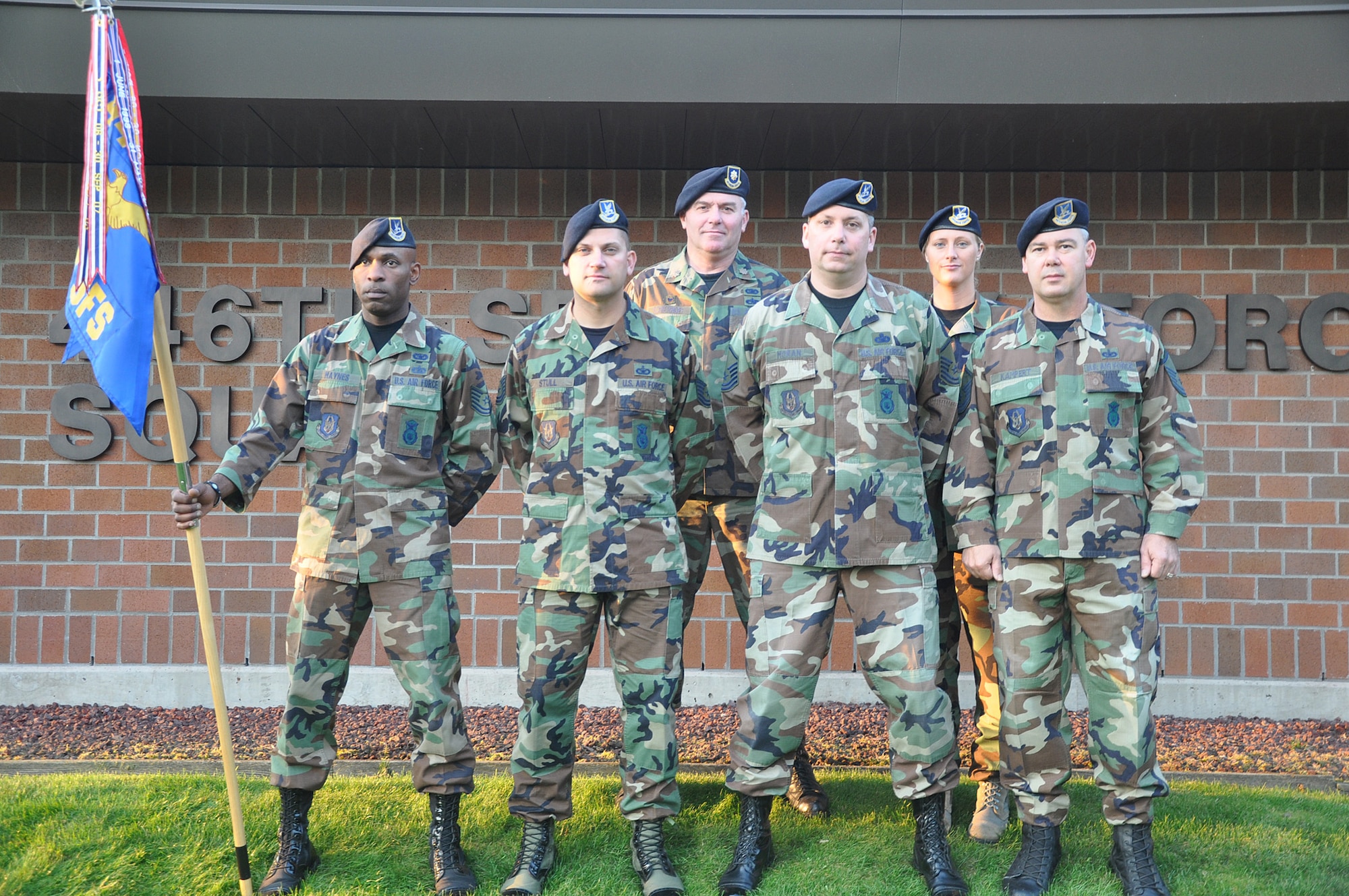 Reservists with the 446th Security Forces Squadron, McChord Field, Wash., take one last picture in their woodland battle dress uniforms. Sept. 10.  As of Nov. 1, all Airmen must wear the Airman Battle Uniform for their utility uniform. (U.S. Air Force photo by 2nd Lt. Denise Hauser)