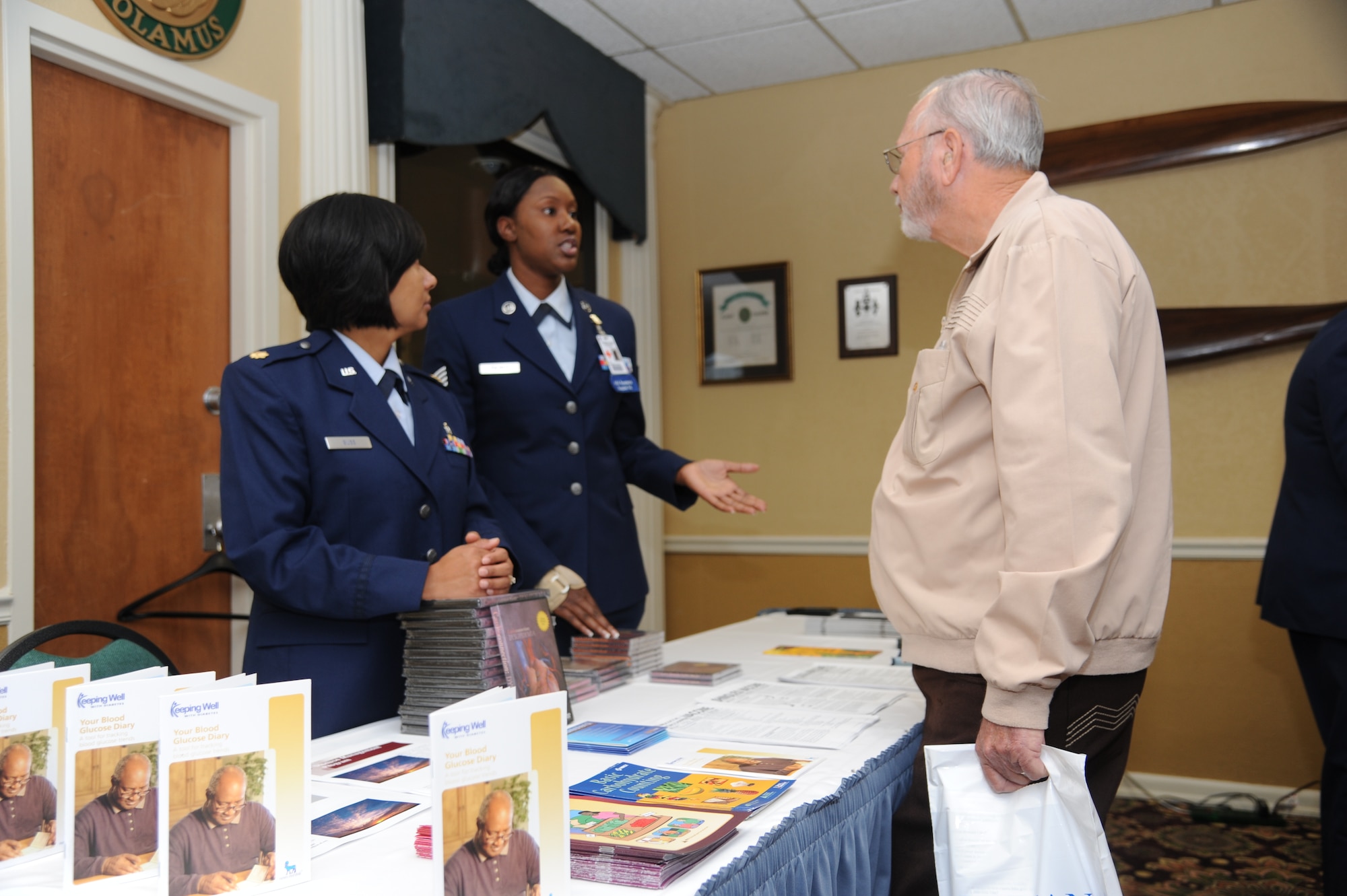 Maj. Fara Buss and Staff Sgt. Kareema Palmer offer health advice to retired Master Sgt. John Mitchell on Sept. 24 at the Columbus Club. According to Amy Kenard, Columbus Retiree Services, some retirees came from as far away as Georgia to attend the event. (U.S. Air Force photo/Airman 1st Class Chase Hedrick)
