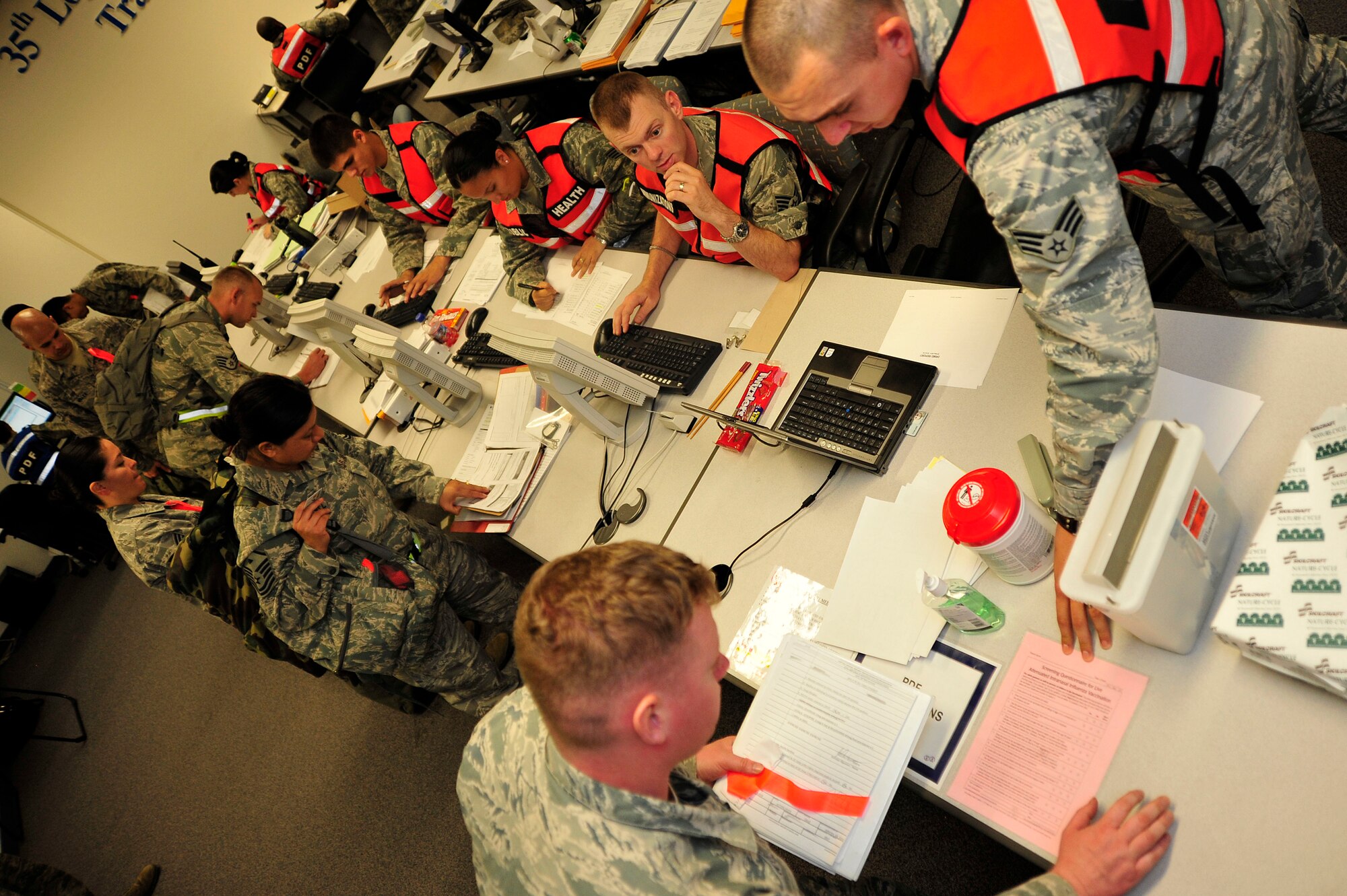 MISAWA AIR BASE, Japan - Airmen make their way through the personnel deployment function line during an initial readiness response exercise here Sept. 30. The PDF is the final check ensuring all deploying airmen's paperwork and medical records are complete and up-to-date before leaving. (U.S. Air Force photo/Staff Sgt. Nathan Lipscomb)