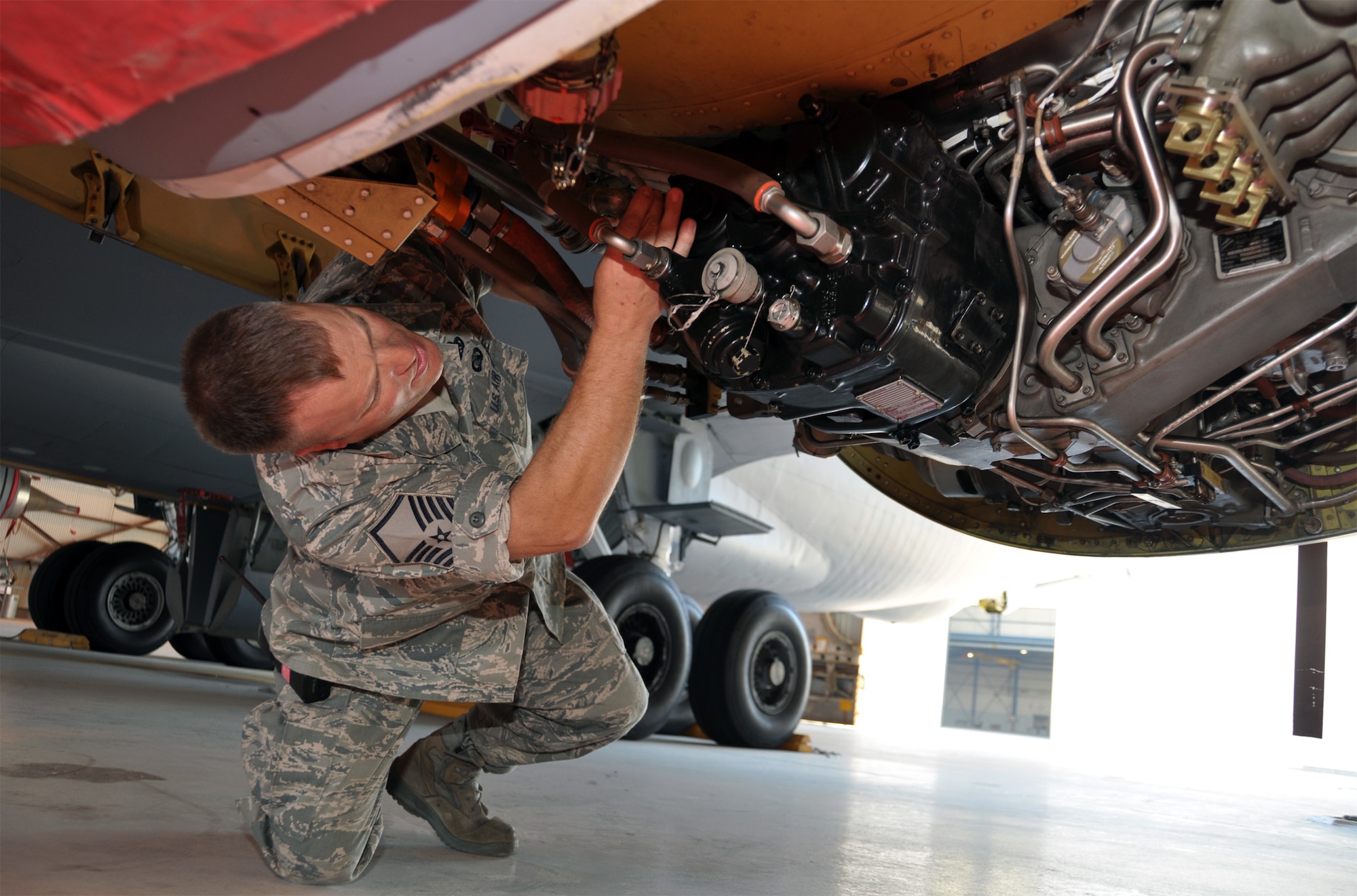 Master Sgt. Bruno DeBacker inspects the engine fire containment system on the port engine of a KC-135 Stratotanker parked inside the Pride Hangar at March Air Reserve Base, Calif., Aug. 24, 2011. DeBacker has exchanged letters and U.S. flags with students in Junction City, Ohio, for nearly a decade.  (U.S. Air Force photo/Tech. Sgt. Joe Davidson