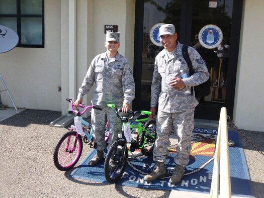 Tech. Sgt. Dean Cardenas (left) and Tech. Sgt. Isias Lara prepare to deliver two bicycles to the children living at the Path of Life Ministries shelter, July 14, 2011.  The shelter is located on former March Air Force Base property.  Cardenas is the president of Air Force Sergeant's Association Chapter 1360, based at March Air Reserve Base, Calif. (Courtesy photo)