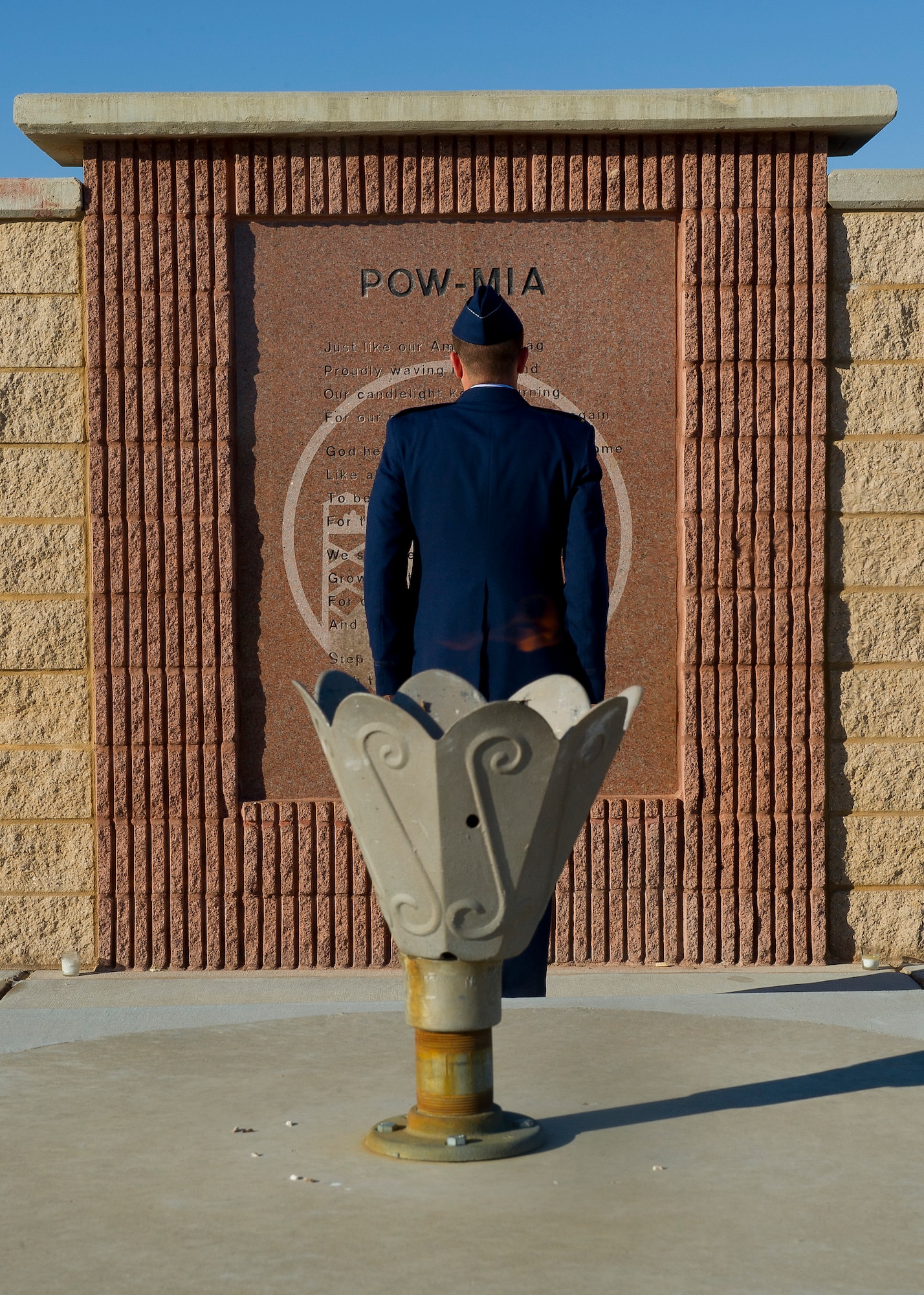 HOLLOMAN AIR FORCE BASE, N.M. -- A Holloman Airman stands vigil in front of the Prisoners of War/ Missing in Action Memorial at Heritage Park Sept. 29, 2011, as part of this year’s POW/MIA Recognition Day. Holloman’s Basic Expeditionary Airfield Resources Base Airmen took turns standing at attention in front of the memorial in 30-minute increments for a total of 24 hours, while the eternal flame remained lit behind them, signifying continued remembrance and unwavering resolve for America's POWs and MIAs. (U.S. Air Force photo by Senior Airman John D. Strong II/ Released)