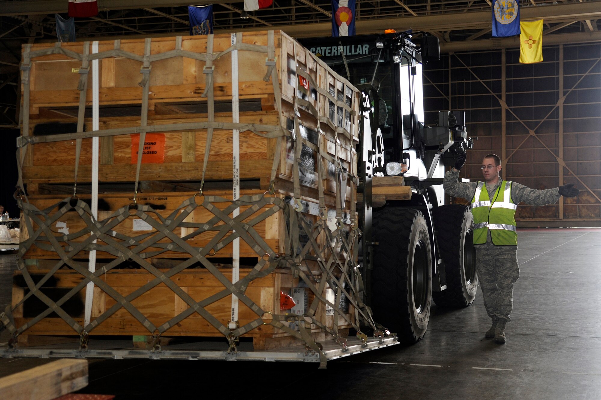 MISAWA AIR BASE, Japan - Airman 1st Class Matthew Gray, 35th Maintenance Squadron, moves cargo into a hangar for processing during an initial readiness response exercise here Sept. 29. The 35th Fighter Wing is currently going through an initial readiness response exercise to prepare for an upcoming operational readiness inspection this December and this is the largest, most significant passenger and cargo movement so far for this exercise.. (U.S. Air Force photo/Tech. Sgt. Marie Brown)