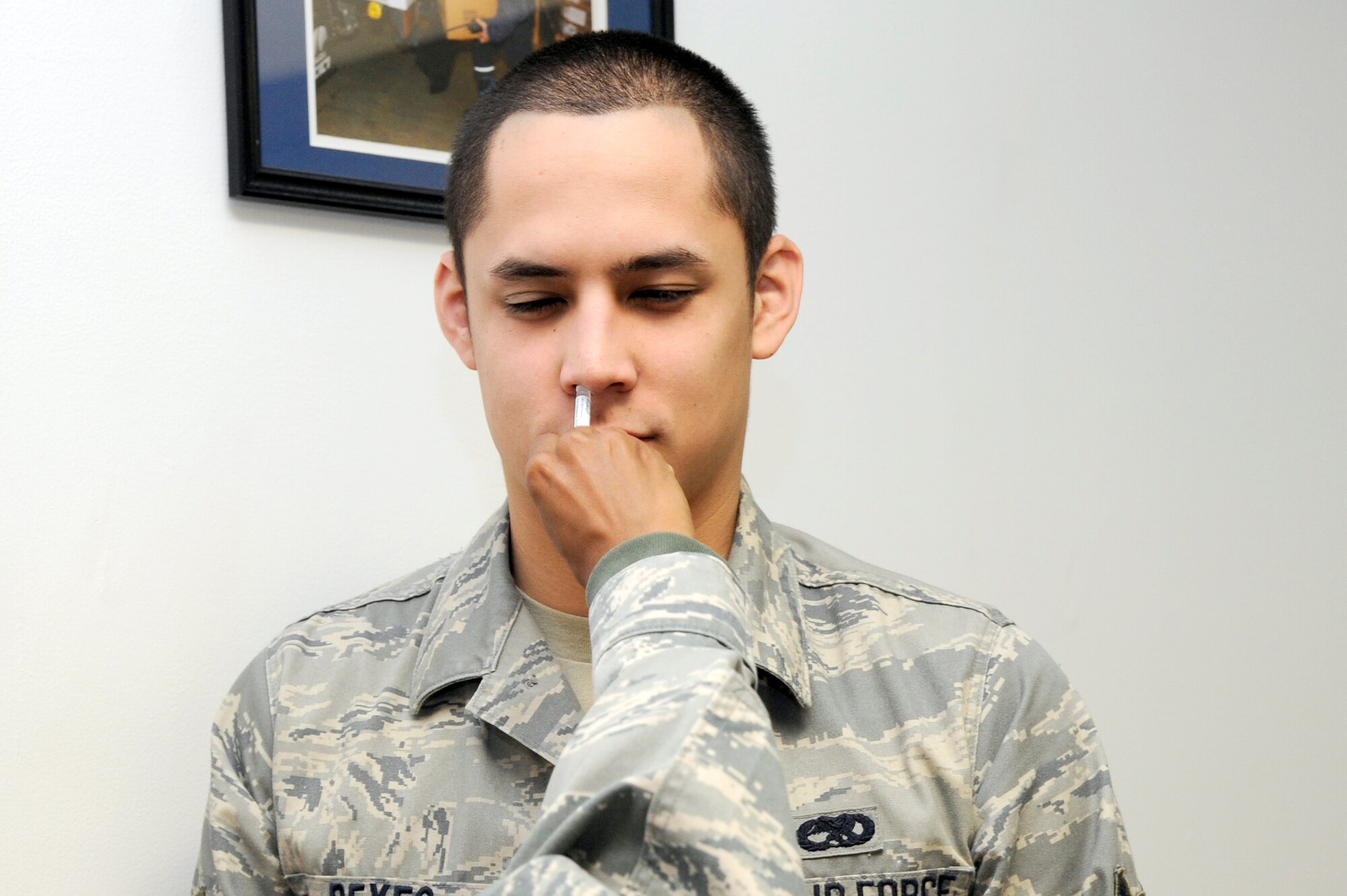 MISAWA AIR BASE, Japan - Airman 1st Class Ian Reyes, 35th Aircraft Maintenance Squadron, receives real nasal flu mist as he processes through a simulated personnel deployment line here Sept. 29. The 35th Fighter Wing is currently going through an initial readiness response exercise to prepare for an upcoming operational readiness inspection this December. (U.S. Air Force photo/Tech. Sgt. Marie Brown)