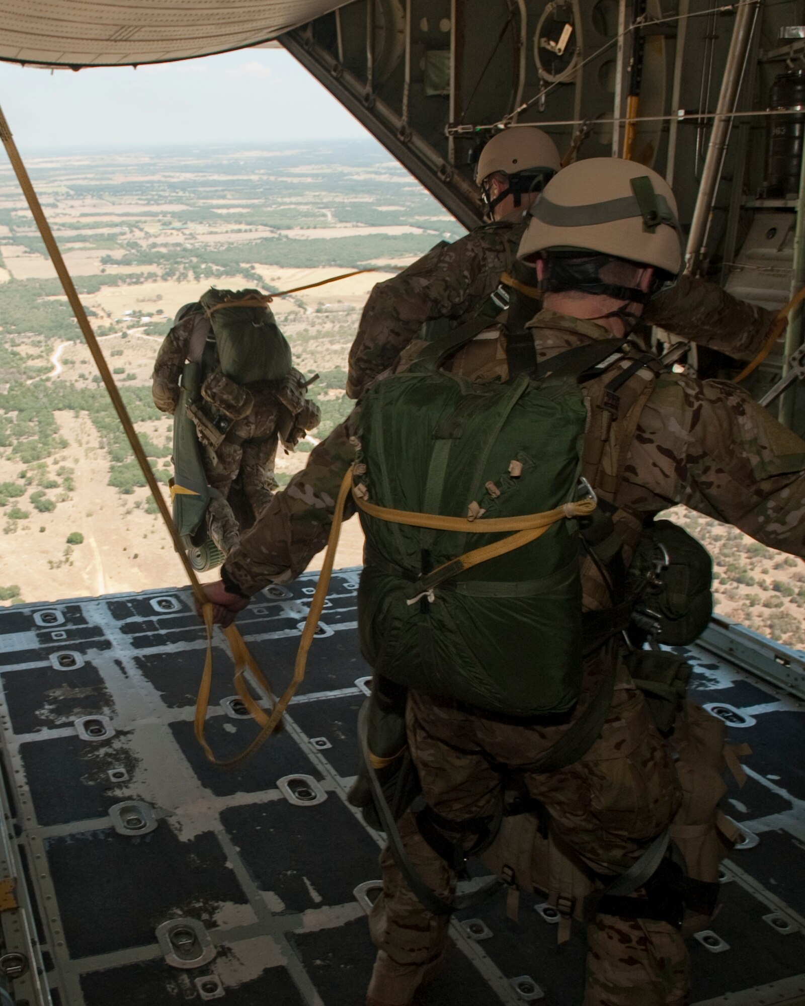 181st Special Operations Weather Team (SOWT), Texas Air National Guard members jump out of a C-130 aircraft belonging to the 136th Airlift Wing during a tactical exercise at Mineral Wells, Texas, Aug. 26, 2011. The SOWT are known for being trained 'thrill junkies' who operate in all six geographic disciplines: mountain, desert, arctic, urban, jungle and water. (U.S. Air Force photo by Senior Master Sgt. Elizabeth Gilbert)