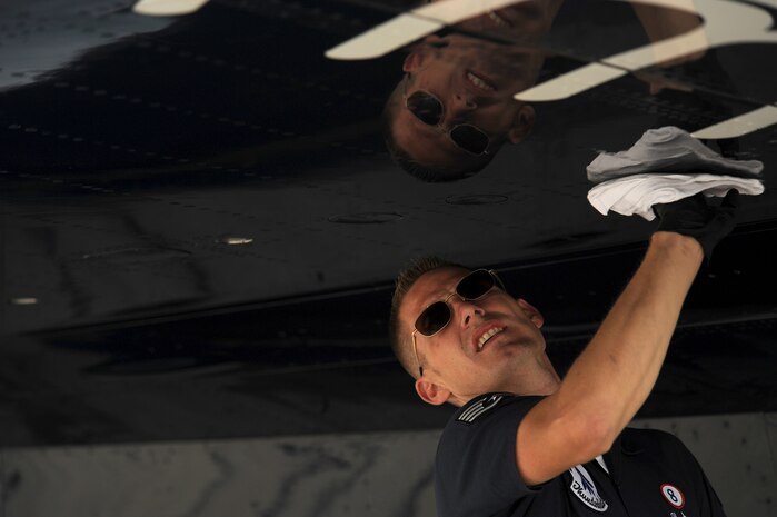 Staff Sgt. Andrew Hartman, Thunderbird 8 assistant dedicated crew chief, wipes down his jet at Cleveland Hopkins Airport, Cleveland, OH, Sept. 5, 2011.(U.S. Air Force photo/Staff Sgt. Larry E. Reid Jr., Released)