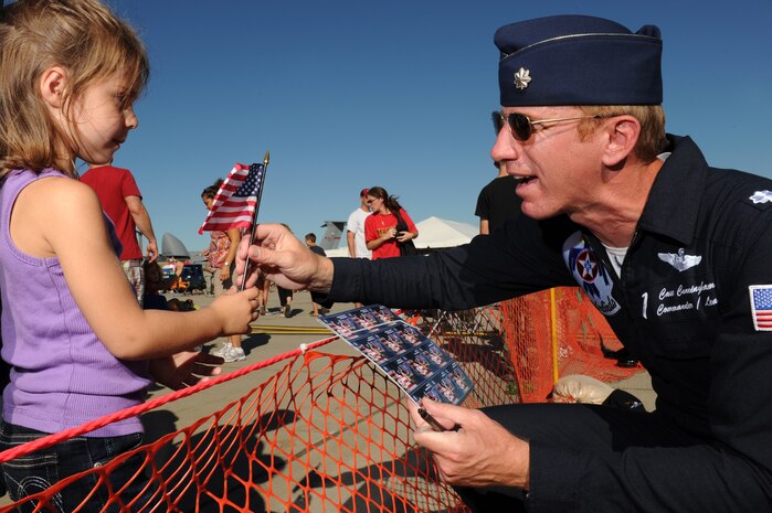 Lt. Col. Case Cunningham, Thunderbird 1, Commander/Leader, U.S. Air Force Air Demonstration Squadron "Thunderbirds", presents a young fan with a flag that was flown in his jet during the Thunder of Niagara Air Show, Niagara Falls, N.Y., Sept. 10, 2011. The Thunderbirds had the honor of performing in the great state of New York on the 10th anniversary weekend of Sept. 11th.(U.S. Air Force photo/Staff Sgt. Larry E. Reid Jr., Released)