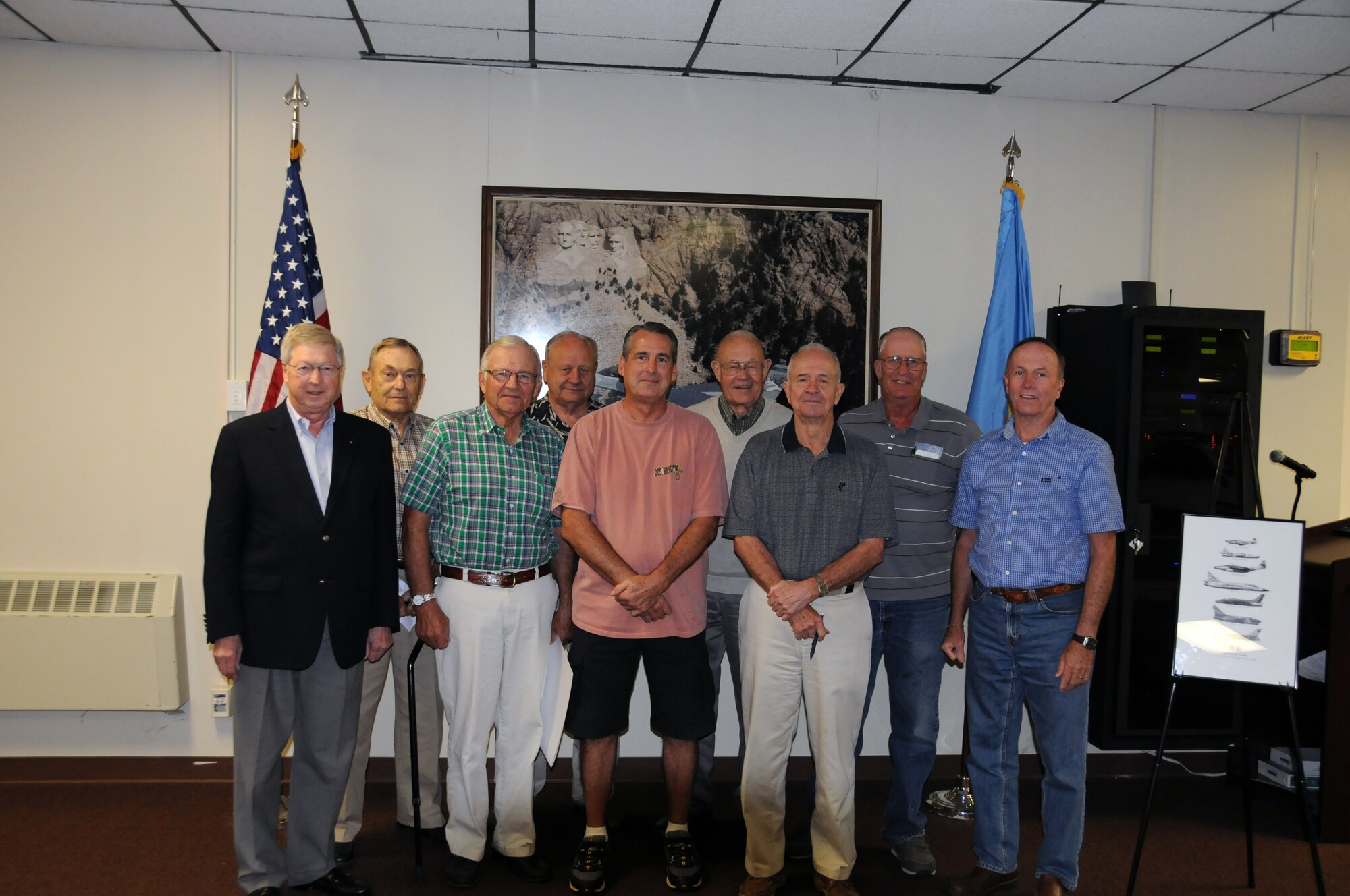 SIOUX FALLS, S.D. - Retired pilots of the South Dakota Air National Guard gather during the retiree's coffee on September 13, 2011.  A special signing was held for those who purchased the limited edition print, "The Rides of the Lobos" at the event.  Pictured left to right; John Kittelson, Verlyn Howe, Carl Palmberg, Arden Fjellanger, Tom Lien, Bob Jamison, Dan Robar, John Carlson, and Steve Doohen.(Photo by Master Sgt. Nancy Ausland)(RELEASED)USAF