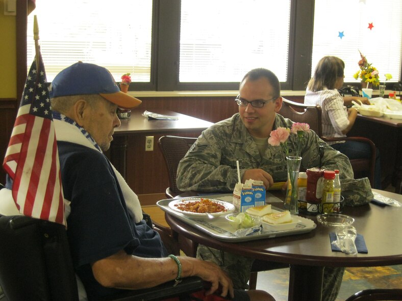 Staff Sgt. Dan Bowles, 414th Maintenance Squadron, speaks with veteran Walter Wheeler during lunch at the Durham Veterans Affairs Medical Center dining facility in Durham, N.C., Sept. 22, 2011.  A group of Airmen from Seymour Johnson Air Force Base spent the day with patients at DVAMC for morale support and to thank them for their service.  Bowles hails from Woodbridge, VA.  (U.S. Air Force photo by Staff Sgt. Mary Holycross)