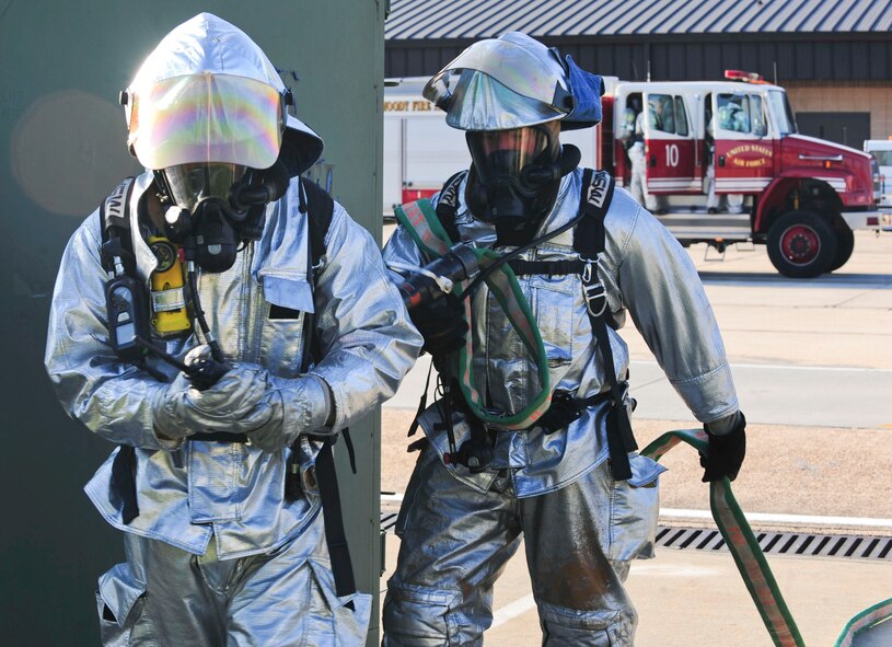 U.S. Air Force Staff Sgt. Nelson Negron, front, and Airman 1st Class Donald Carey, 23rd Civil Engineer Squadron firefighters, wait for the “ok” to enter a simulated burning building during a phase II operational readiness exercise at Moody Air Force Base, Ga., Sept. 29, 2011. The scenario tested the firefighters on how fast they entered the building, cleared rooms, extinguished the fire and rescued victims still in the building. (U.S. Air Force photo by Senior Airman Stephanie Mancha/Released)  