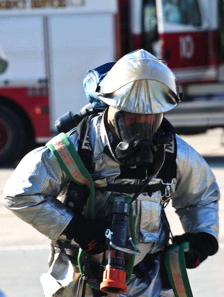 U.S. Air Force Airman 1st Class Donald Carey, 23rd Civil Engineer Squadron firefighter, rushes towards a simulated burning building during a phase II operational readiness exercise at Moody Air Force Base, Ga., Sept. 29, 2011. Carey was one of seven firefighters who responded to the scenario and simulated putting out the fire. (U.S. Air Force photo by Senior Airman Stephanie Mancha/Released) 