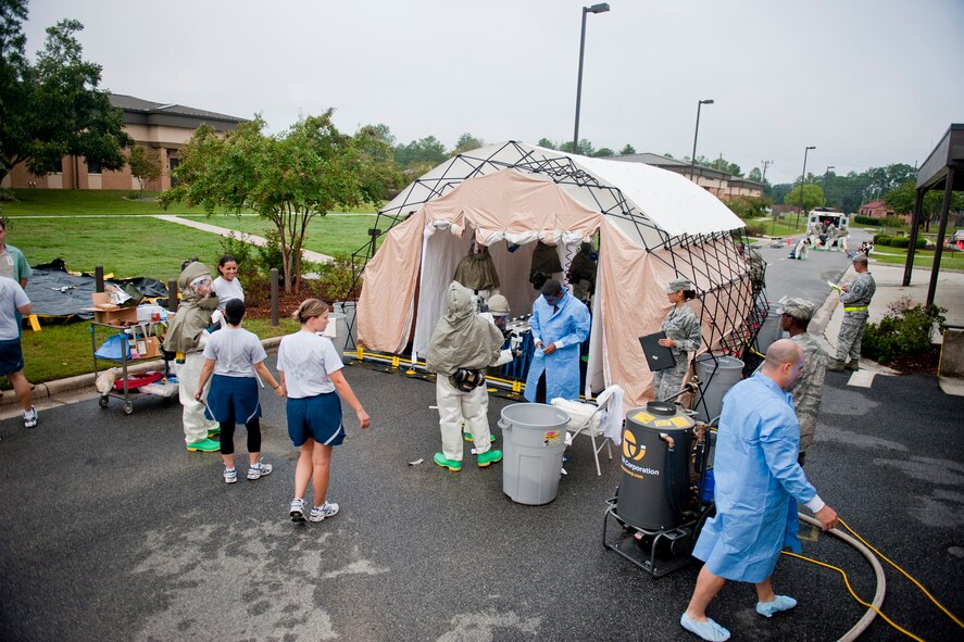 Medical personnel treat patients at a decontamination tent during a mass casualty exercise Sept. 23, 2011, at Moody Air Force Base, Ga. The decontamination tent was the last stop for patients before heading inside the 23rd Medical Group building to be assessed and receive more treatment. (U.S. Air Force photo by Staff Sgt. Jamal D. Sutter/Released) 