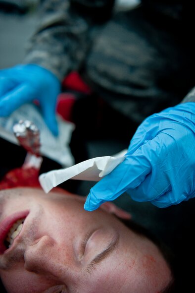 U.S. Air Force Senior Airman Timothy Elliott, 23rd Logistics Readiness Squadron vehicle maintenance journeyman and simulated victim, receives treatment from a medical responder during a mass casualty exercise Sept. 23, 2011, at Moody Air Force Base, Ga. Mass casualty exercises test the base’s ability to respond to hazards such as terrorist attacks or natural disasters. (U.S. Air Force photo by Staff Sgt. Jamal D. Sutter/Released)