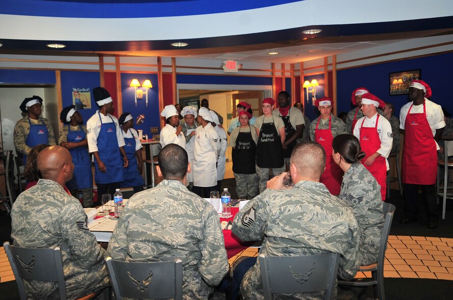 Participants of the Warrior Chef competition await the judge’s results for the first place winner Sept. 28, 2011. Airmen and civilians from the 4th Fighter Wing participated in the event, which challenged competitors to create an entrée from a basket of mystery ingredients in a 45 minute time span. (U.S. Air Force photo by Senior Airman Marissa Tucker)