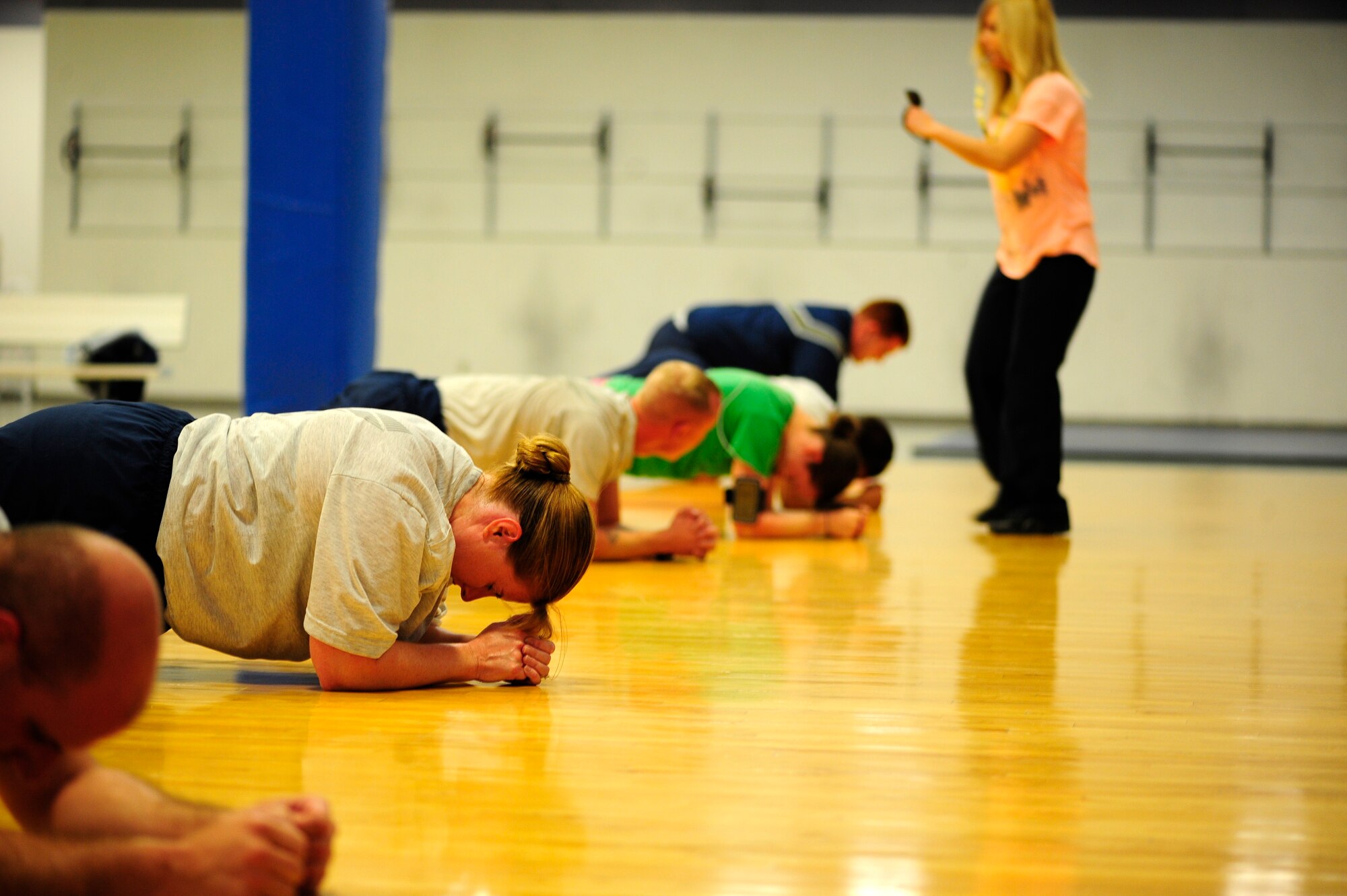 Pinar Teel, fitness center personal trainer,  motivates students at the base ‘boot camp’ Tuesday. The class is held  Monday - Friday at 8 a.m. and 3 p.m. (U.S. Air Force photo/Airman 1st Class Taylor Curry)